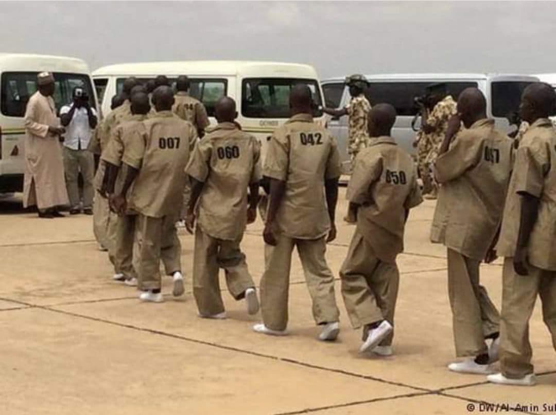 A number of former Boko Haram fighters line up in a holding facility