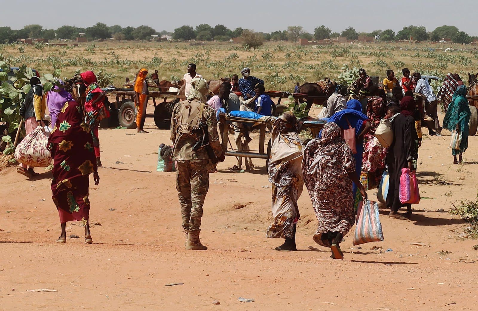 Families escaping the violence in Ardamata cross into Chad in early November. Photo: El Tayeb Siddig/Reuters