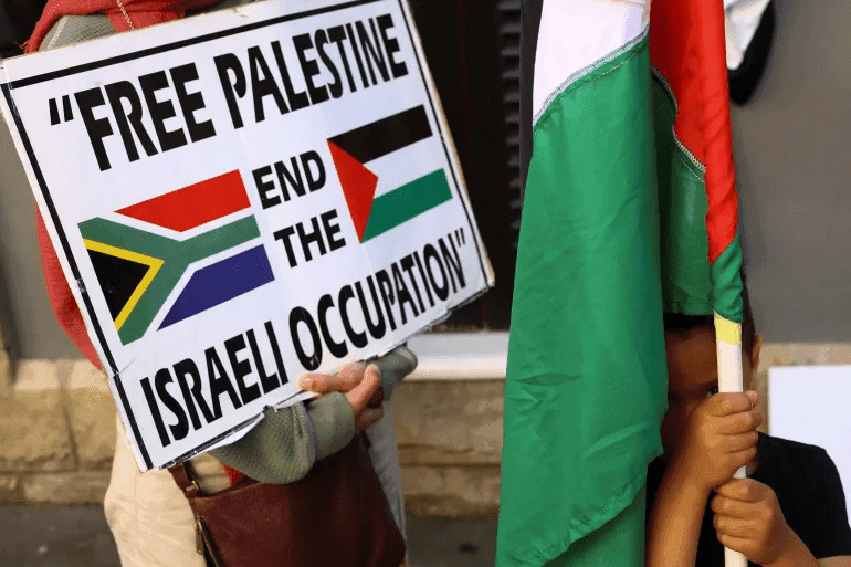 A boy holds a Palestinian flag during a demonstration to express support for the people of Palestine, in Cape Town, South Africa, Oct. 9, 2023 Photo: Esa Alexander/Reuters