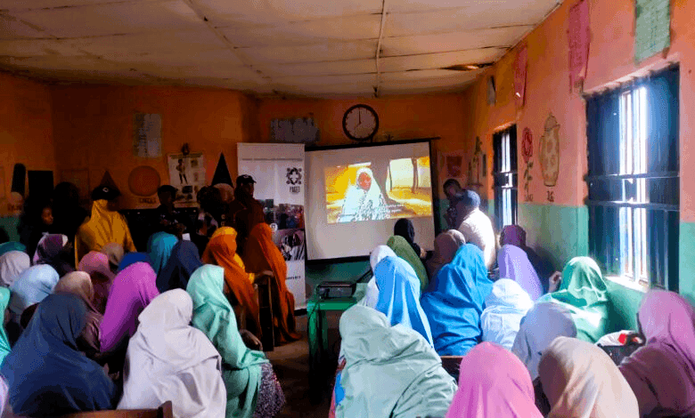 Over 50 women in Malali gathered in a classroom to watch a documentary on women who could not have an education. Photo: Nathaniel Bivan/HumAngle.
