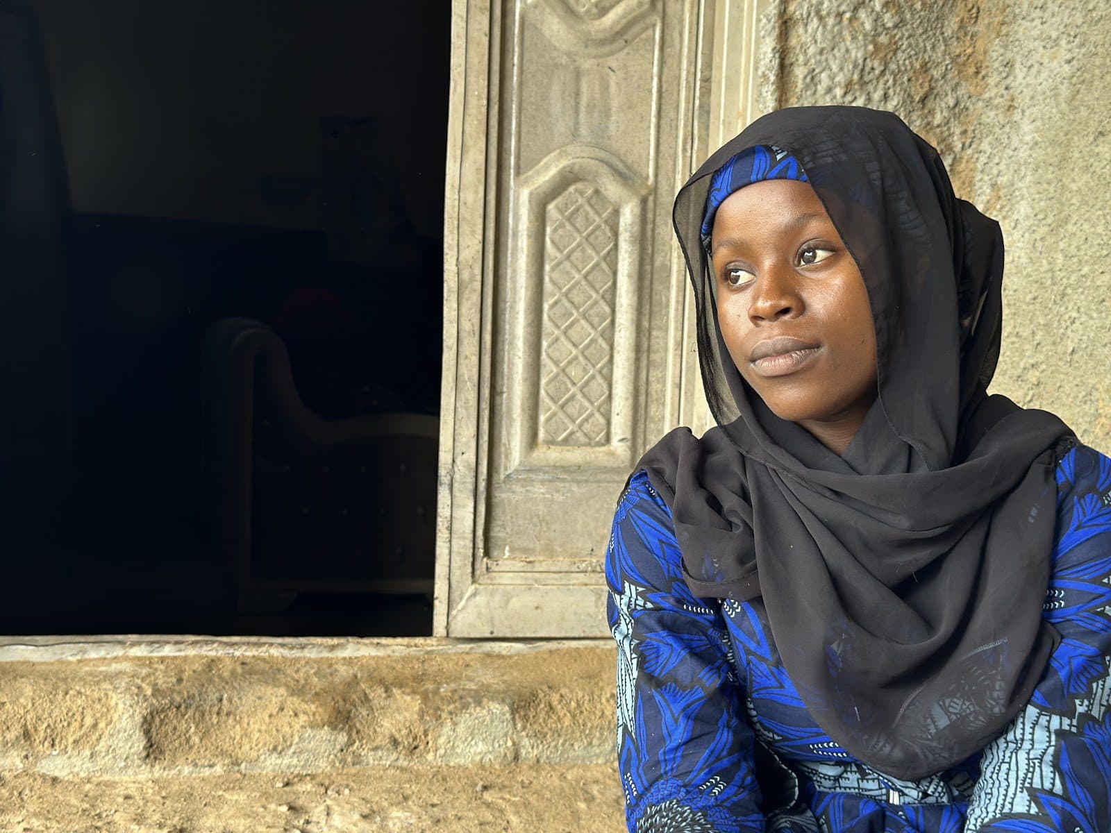 Na’empere Daniel looks to her side at a location in Yauri, North West Nigeria. Photo: Hauwa Shaffii Nuhu/HumAngle. 