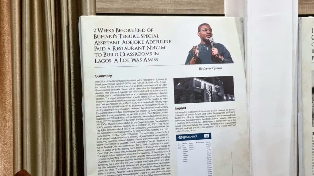An open newspaper featuring an article about financial irregularities with a man
