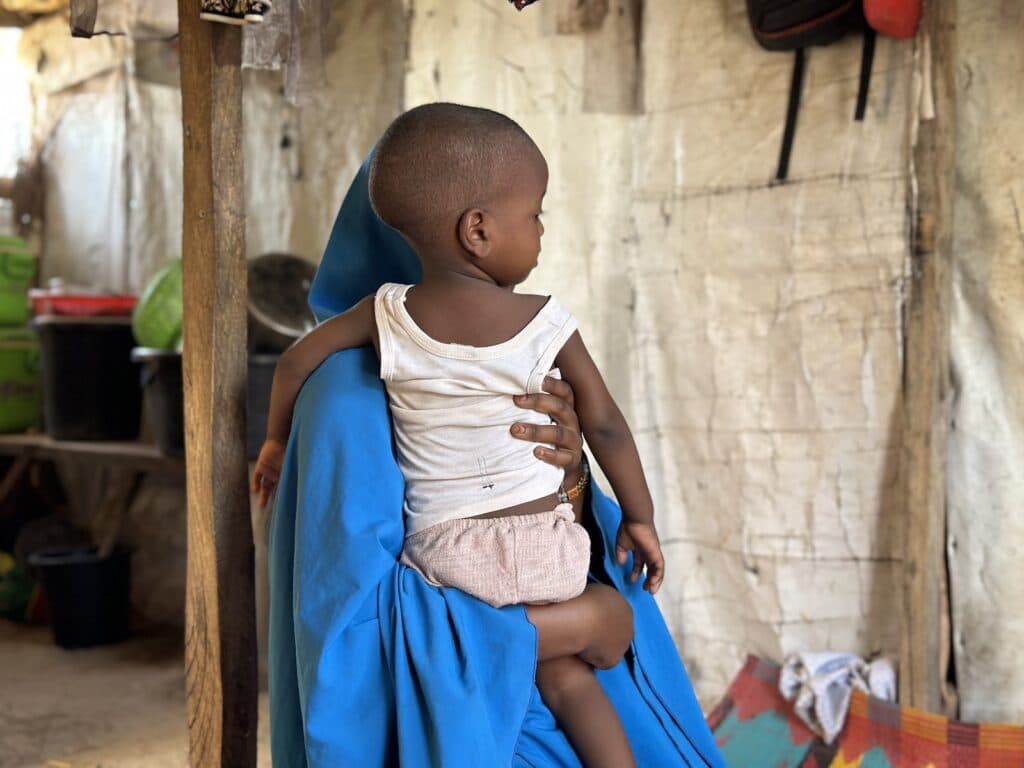 Child sitting on a person