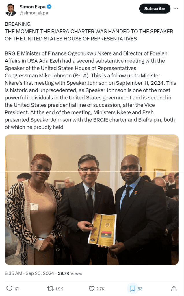 Two individuals standing with a man holding a certificate and pin, caption describes handing over of Biafra Charter to US House Speaker.