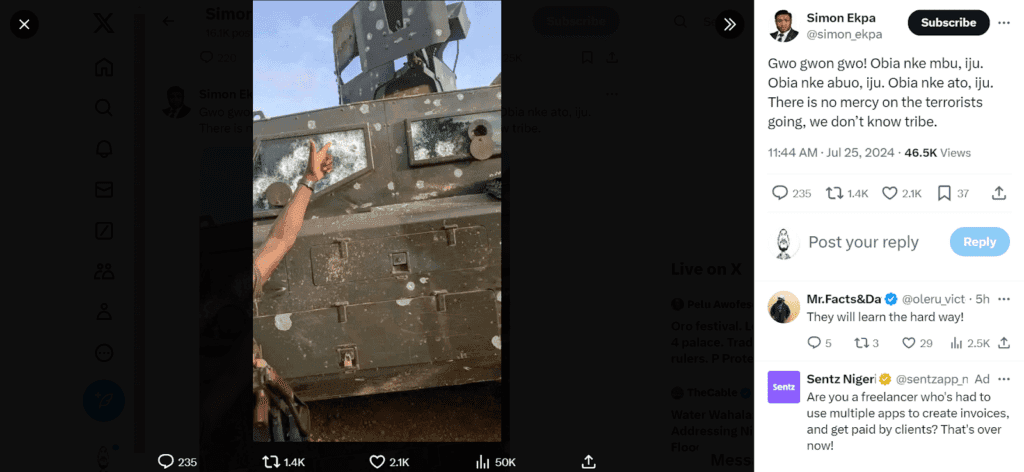 Person pointing at bullet holes on armored vehicle
