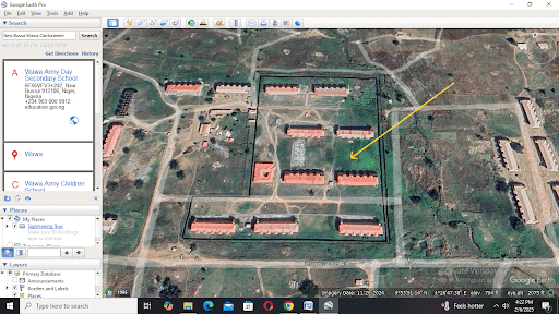 Satellite view of a compound with multiple buildings, highlighted area, and location details displayed on the left.