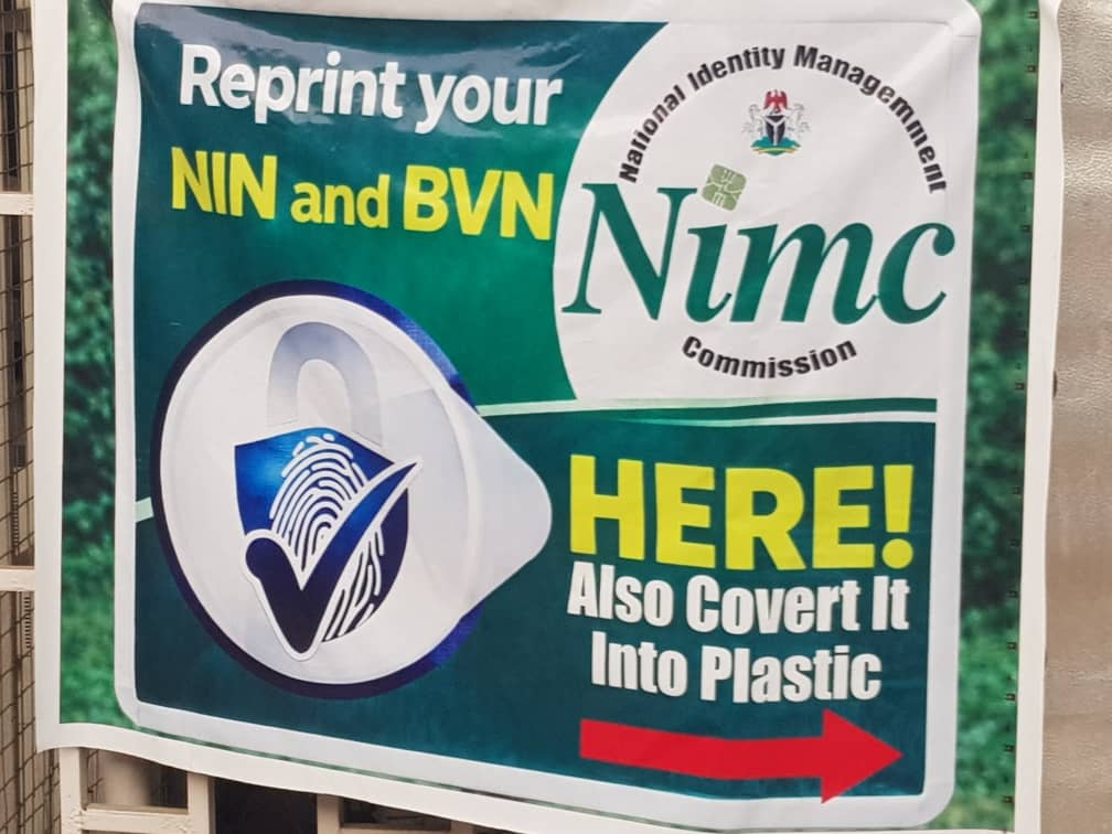 Sign for reprinting and plastic conversion of NIN and BVN at NIMC Commission with an arrow pointing right.