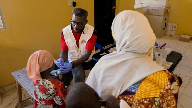 An MSF medical personnel testing a girl brought by her mother for experiencing fever and convulsion before being diagnosed with malaria. Photo: MSF/Abba Adamu Musa /Alexandre Marcou