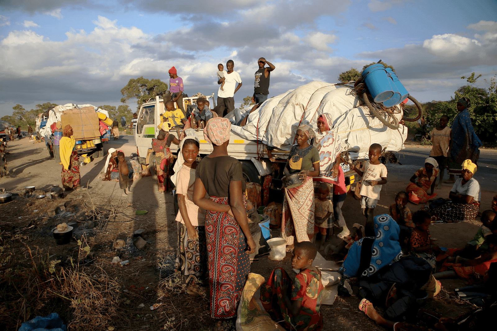 A group of people standing on the side of a road.
