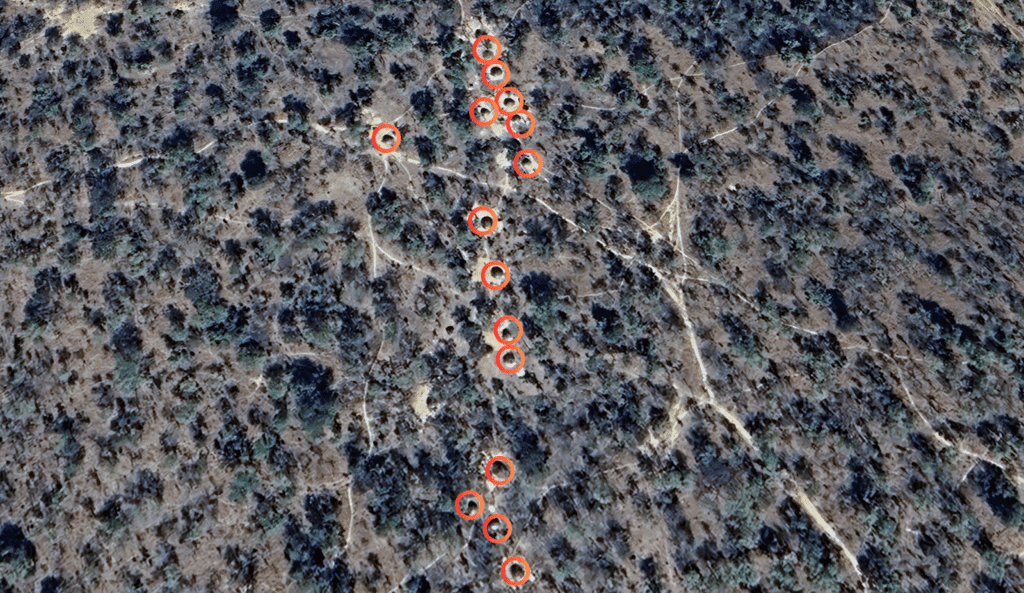 Aerial view of a landscape with red circles marking specific locations.