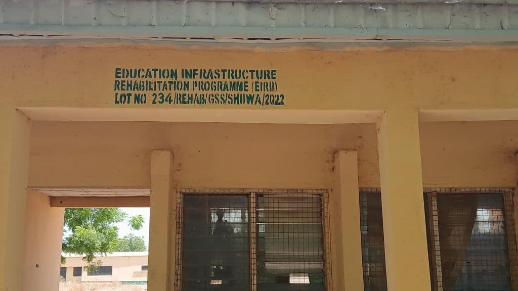 Text on a wall reads, "EDUCATION INFRASTRUCTURE REHABILITATION PROGRAMME (EIRP) LOT NO 234/REH/AB/GSS/SHOWA/2022."
