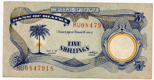 Biafran five shillings note with palm tree, intricate blue patterns, and serial number MU0847918 on textured background.